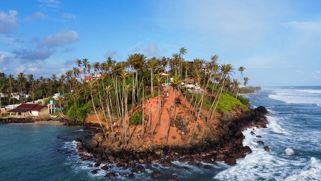 Drone view of Coconut Tree Hill in southern Sri Lanka, where endless palms rise above the turquoise coastline.