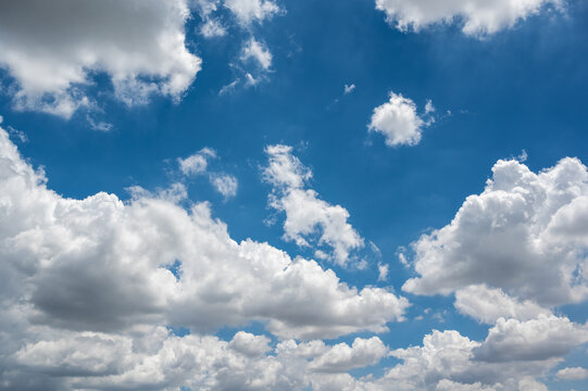 Bright Blue Sky with Fluffy White Clouds in Daytime Serenity