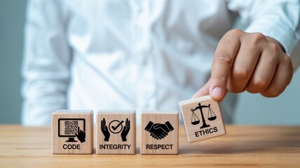Fototapeta premium Person arranging wooden cube with business ethics icon on a table