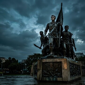 Historical bronze monument of Katipunan revolutionaries under dramatic sky