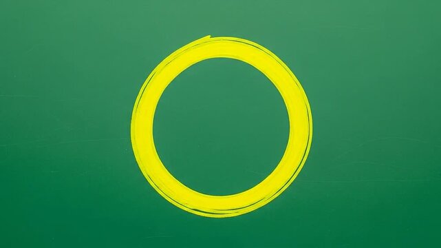 A bright yellow circle drawn with chalk on a dark green board