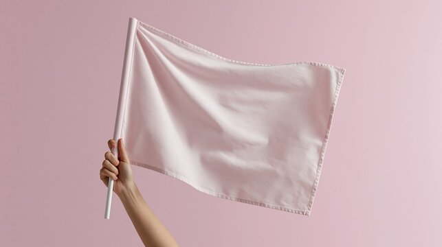 Female hand holds waving blank plain solid pink flag against solid pink background perfect for custom design project and mockup template