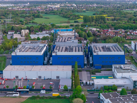 Aerial view of the Digital Realty Frankfurt FRA30 data center complex with blue industrial buildings and cooling systems in Frankfurt am Main, Hessen, Germany.