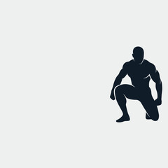 Obraz premium Muscular male bodybuilder silhouette kneeling in a powerful pose