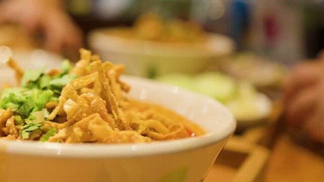 Traditional Northern Thai Khao Soi Curry Noodle Soup in Ceramic Bowl