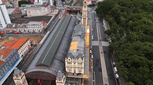 Aerial view of Luz Station with trains entering and leaving in S&atilde;o Paulo, Brazil. Crane down, tracking and tilt camera movement.