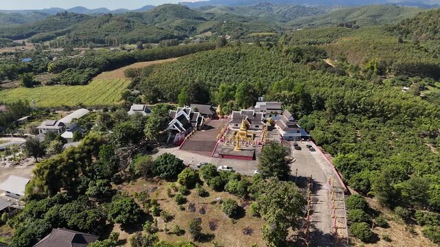 Aerial view of Buddhist temple named Wat Phra That Mok Mung Mueang located in Thoeng district of Chiang Rai province of Thailand.
