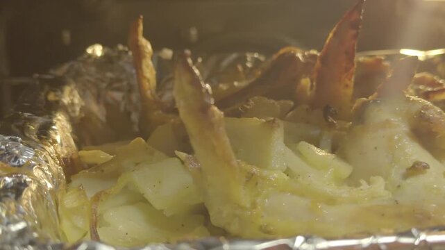 Roasted Chicken and Potatoes in Foil Tray Inside Oven, Hot Steaming Food