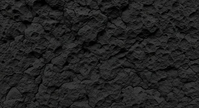 Textured black volcanic basalt stone reveals a rough pitted surface for a dramatic Wallpaper Background image