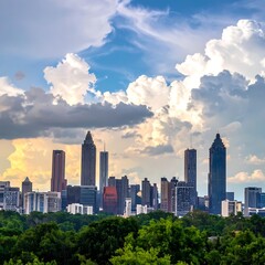 Fototapeta premium City skyline with green trees and cloudy sky.