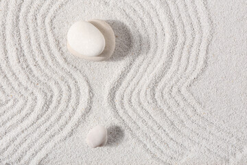 Obraz premium Stones on sand with lines in Japanese rock garden, top view. Zen concept