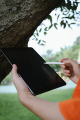 Using Tablet for Plant Identification in Forest – Digital Nature Exploration Concept  © Dara-Sroi