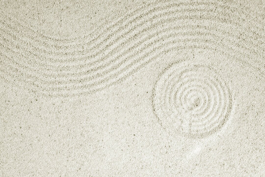 Top view background of zen sand patterns on white beach, wavy lines texture on sandy surface, Japanese zen garden concept for meditation and relaxation spa background.