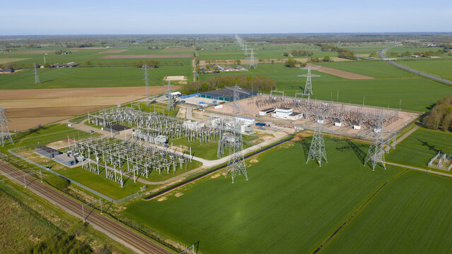 Aerial view of 380 kV high voltage grid station between Ens and Zwolle, showing power lines, pylons, conductors, substations, and energy transition infrastructure.