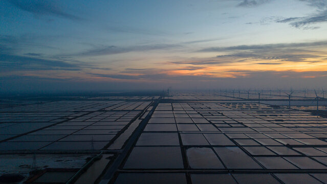 Sunset Over Coastal Salt Farm Wind Power Facility