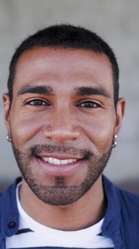 Happy Latin man smiling in front of camera - Young male lifestyle concept - Vertical video