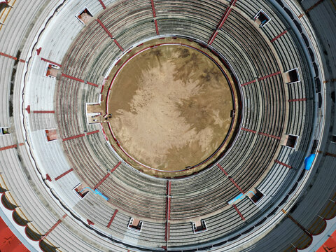 An impressive aerial top-down perspective of the Nuevo Progreso Bullring in Guadalajara, Mexico, highlighting its iconic circular architecture and empty arena.