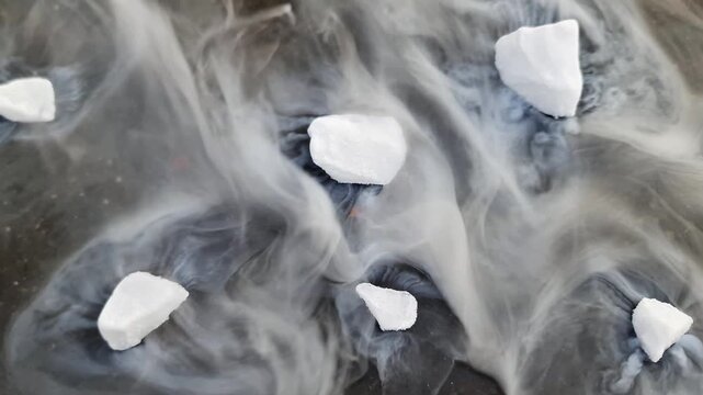 Fluid Dynamics of Dense Smoke from Sublimating Dry Ice on Wet Surface