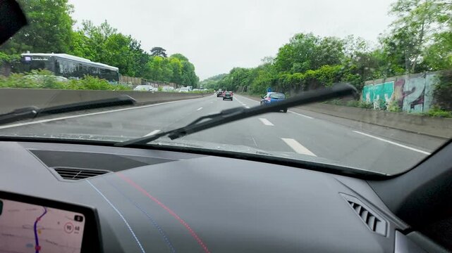 Driving on a Paris Highway with Windshield Wipers in Overcast Weather