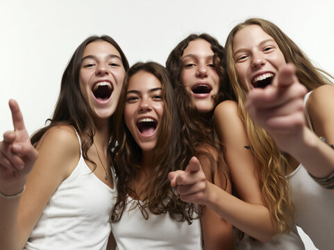 Four Friends Laughing Joyfully: A group of four young women sharing a moment of pure joy, their faces alight with laughter and shared amusement.