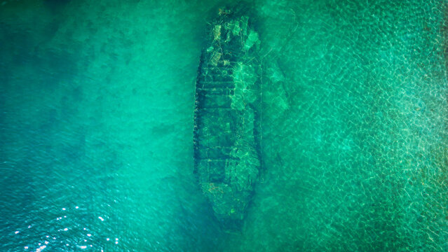 Aerial view of the Kontesa shipwreck submerged in crystal clear turquoise waters of the Adriatic Sea in Necujam, Split-Dalmatia County, Croatia.