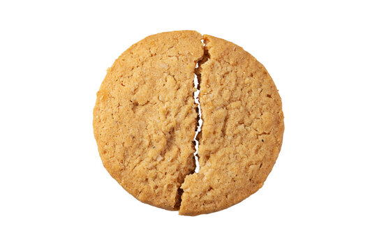 A cookie broken in the middle on a white background.
