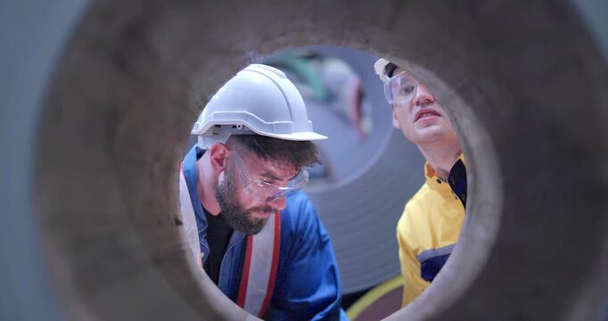Metal workers conduct quality control inspections