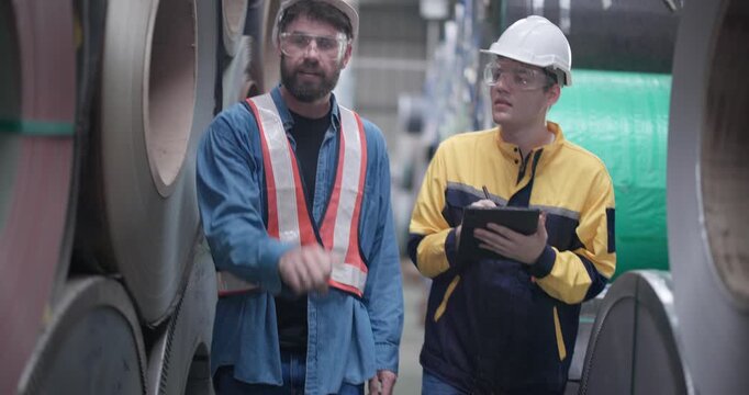 Metal workers conduct quality control inspections