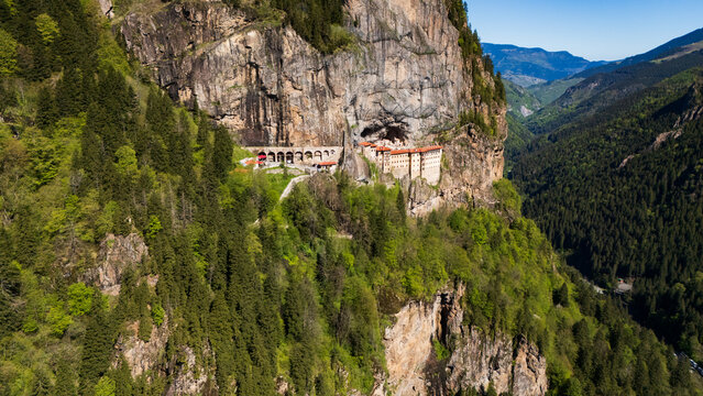 drone shot of the iconic rock-cut Sumela Monastery surrounded by misty valleys and alpine forests in Trabzon, Turkey