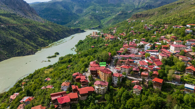 aerial view of Kemaliye town and the Karasu River gorge, Turkey. Majestic drone landscape showing traditional houses nestled between steep limestone cliffs and the Euphrates