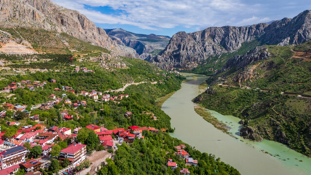 aerial view of Kemaliye town and the Karasu River gorge, Turkey. Majestic drone landscape showing traditional houses nestled between steep limestone cliffs and the Euphrates