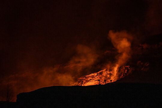 Sulfur dioxide emissions from the Halema`uma`u vent, glows at night. Kīlauea, Hawaiʻi Volcanoes National Park.