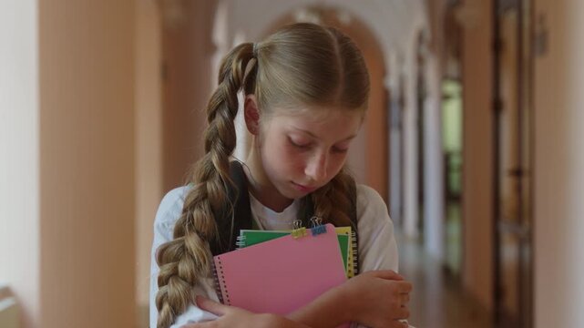 Portrait Caucasian sad little girl student looking at camera fail exam in school teen pupil learner schoolgirl upset lonely child kid college hall frustrated alone study learning problem bad education