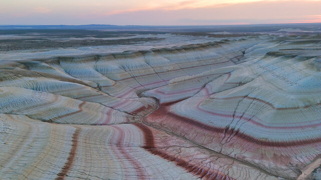 multicolored canyon at sunset Kyzylkup is a natural landmark in the Mangystau region of Kazakhstan. It is a group of colorful hills with multicolored layered slopes that resemble
