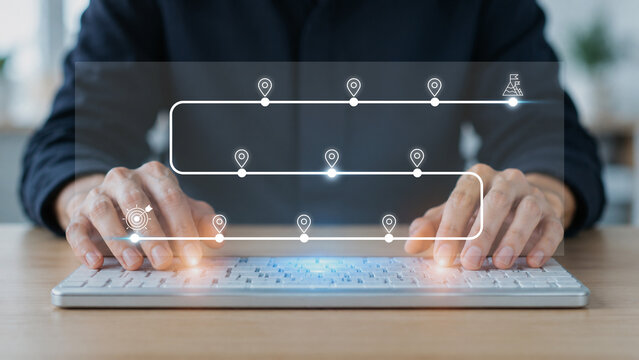 Business and Project Roadmap Concept. Typing on a computer keyboard with roadmap overlay representing steps in a project or strategic planning process. Waypoint icons and ends with goal achievement.