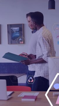 Vertical video: Two men opening green folder, tapping phone, reviewing eco metrics with hex icons
