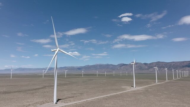 Locked Off Camera Wind Turbines in Oper Desert Drone Aerial View