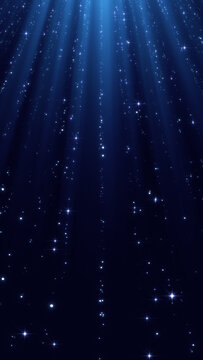 christmas and new year blue background with string shiny stars glitter and particles falling and light rays, vertical social media design element