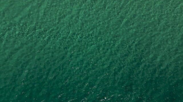 Aerial Tilt Up from Atlantic Ocean to Morro Jable Coastline, Fuerteventura, Spain