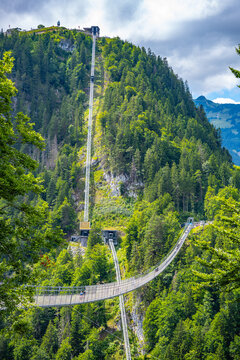 Highline 179 is a pedestrian bridge that spans a river gorge in Austria. It links the remains of a castle with a Roman fortress. Visitors cross the bridge to enjoy the scenery and explore history.
