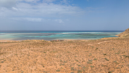 Arid desert coast with turquoise lagoon and ocean horizon. Sokotra, Yemen. © M