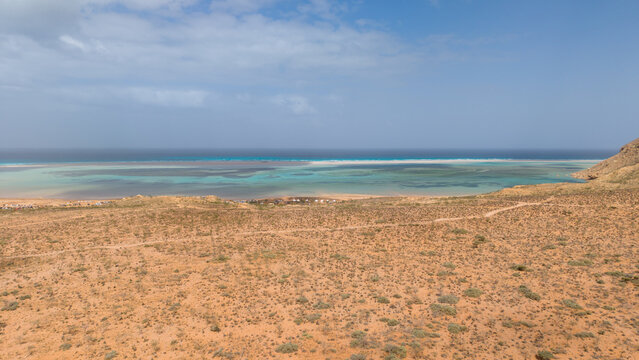 Arid desert coast with turquoise lagoon and ocean horizon. Sokotra, Yemen.