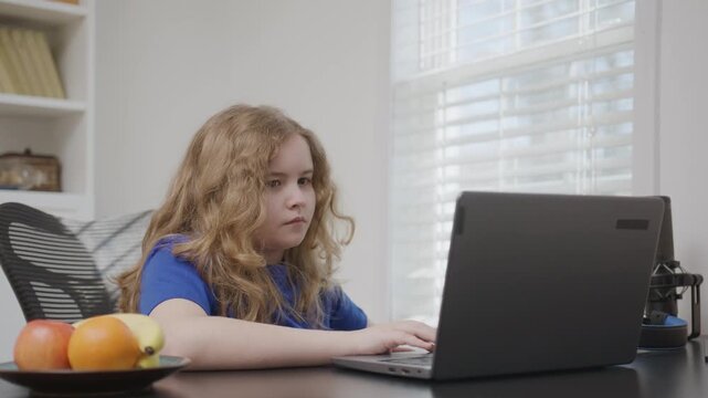 Kid remote education by laptop at home. Distance learning for kids.