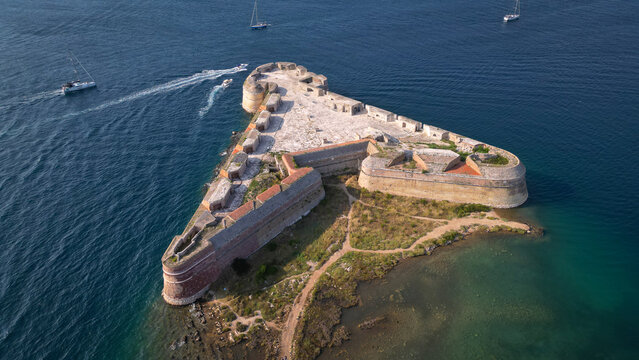 Aerial view of the triangular St. Nicholas Fortress surrounded by the blue Adriatic Sea with boats sailing nearby in Sibenik, Croatia.