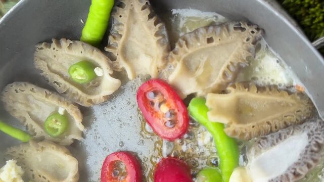 Frying Fresh Foraged Morels in a Pan at a Campsite