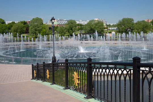 A bridge on the background of a fountain. The territory of the Tsaritsyno Museum-Reserve, Moscow, Russia