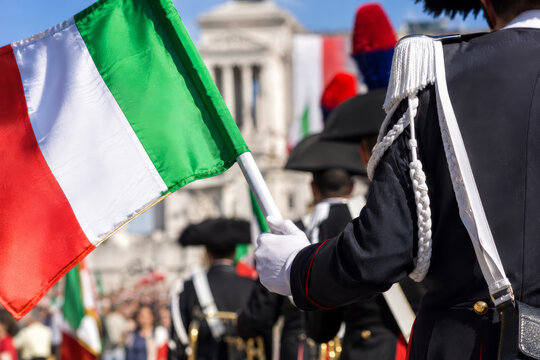 Italian banner with soldier in dress uniform carrying flag at city festival in Rome. Festa della Repubblica.
