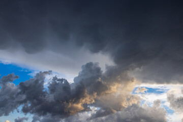 Dark storm clouds gathering with patches of blue sky © Victoria Kondysenko