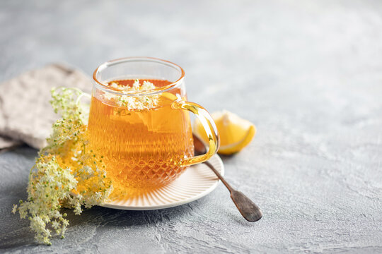 Herbal Tea with Elder flower on grey background. Healing drink