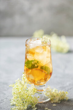 Hugo spritz cocktail  with wine, elderflower syrup, lemon, mint and ice in glass on the table